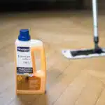 Bidon de Starwax produits entretien des sols posé sur un plancher