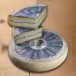 Morbier entier avec 2 morceaux posés dessus
