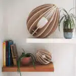 Lampes design en bois posées sur des étagères avec des livres