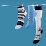 Chaussettes pendues à un fil sur fond bleu